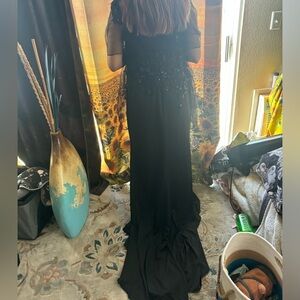 A very nice black dress comes from the brand royal queen collection